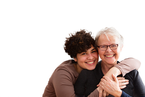 young woman embracing senior woman, both happy together, isolated on white