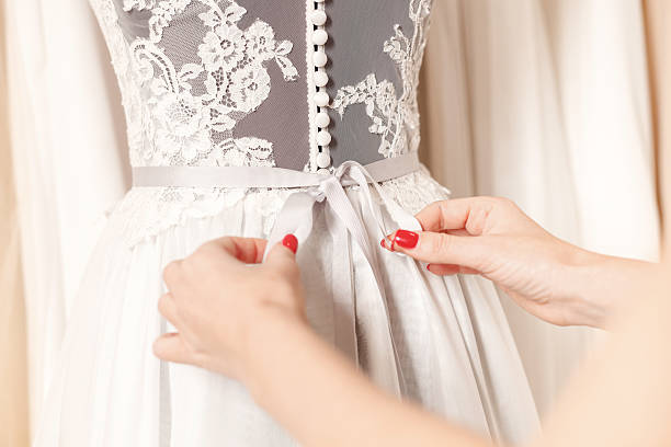 istock Talented fashion designer is fixing wedding dress 535519638