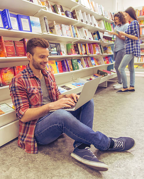 istock Students with gadget at the bookshop 535523304