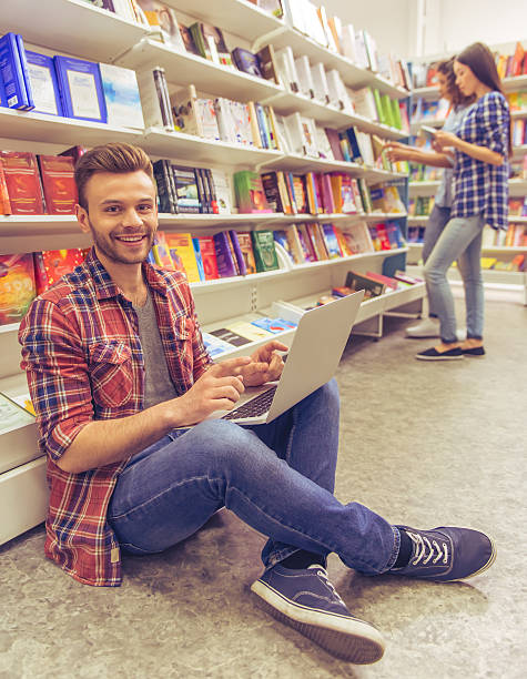 istock Students with gadget at the bookshop 535523414