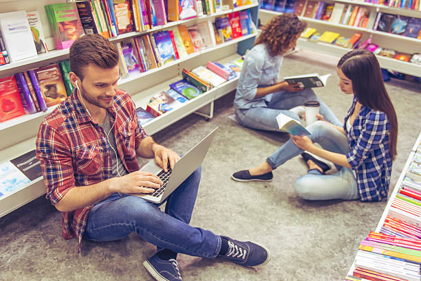 istock Students with gadget at the bookshop 535523572