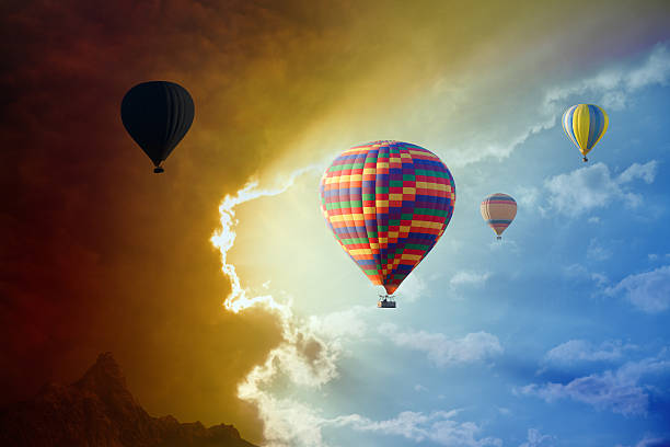 istock Flying hot air balloons in stormy sky 535525366