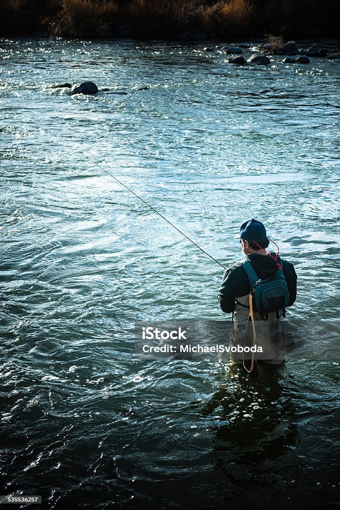 Stream Fishermen A fishermen in waist deep water in river casting. http://blog.michaelsvoboda.com/FishingBanner.jpg Fly-fishing Stock Photo