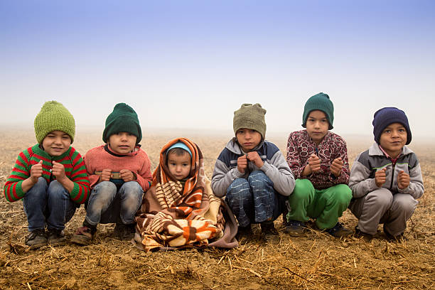 Group of Poor Children Shivering  in Winter Season Outdoor Portrait.