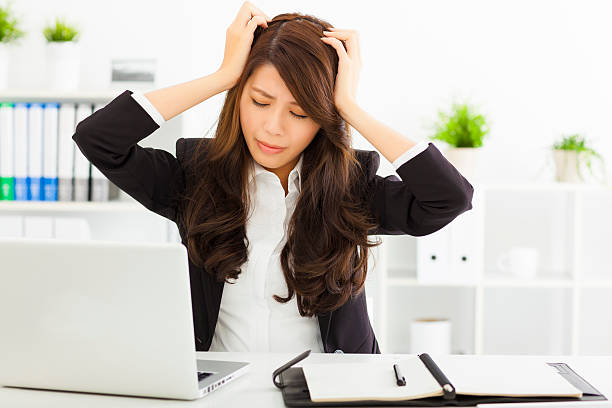 istock stressed  businesswoman sitting in office 535537725