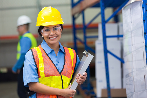 Hispanic female blue collar worker in distribution warehouse