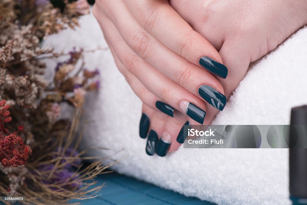 Manicure Beauty treatment photo of nice manicured woman fingernails. Very nice nail art with petroleum blue nail polish. 2015 Stock Photo