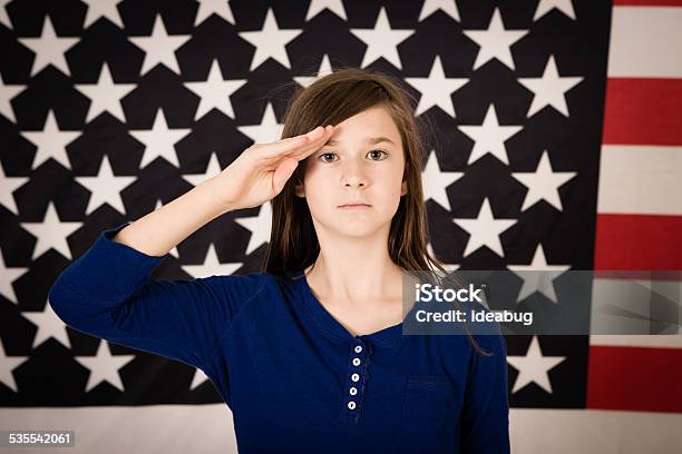 Young Preteen Girl Saluting In Front Of American Flag Stock Photo - Download Image Now