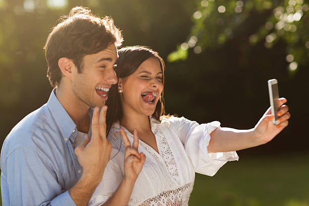 istock Young couple taking a selfie in the park 535542721