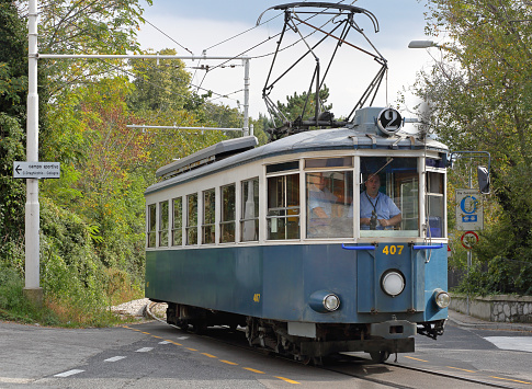 Trieste, Italy - October 13, 2014: Driver cross road at Trieste to Opicina hybrid funicular and tram public transport in Trieste, Italy.