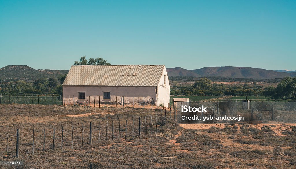 African house with corrugated iron roof in the Swartberg landscape. African house with corrugated iron roof in Swartberg semi desert landscape. Western Cape. South Africa. Landscape - Scenery Stock Photo