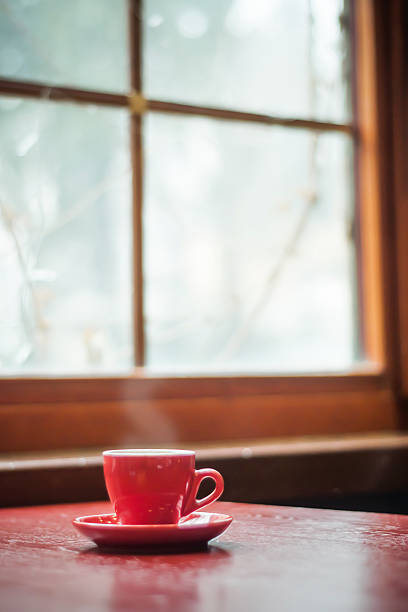 red mug coffee and window - cafe snow stockfoto's en -beelden