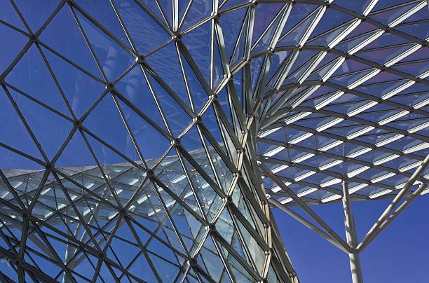 Architectural detail of the Milan Trade fair  roofing Milan, Italy - April 9 2014: Architectural detail of the Milan Trade fair roof, made of glass and steel, facing the blue sky behind. fiera stock pictures, royalty-free photos & images