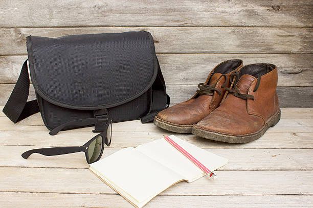istock bag,sunglasses,notebook,pencil and brown leather men's boots 535553699