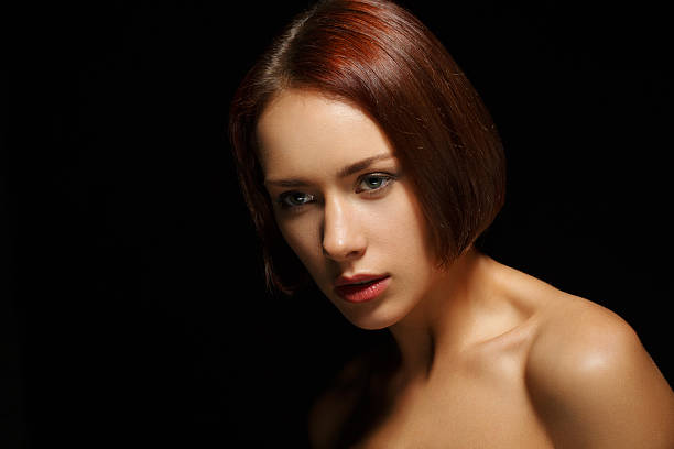 istock Beautiful young woman on dark background 535554125