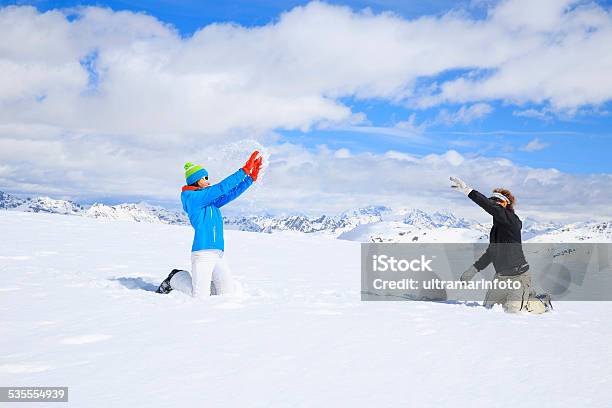 Snowballing Winter Sport Playing Couple Men And Women Snow Skiers Stock Photo - Download Image Now
