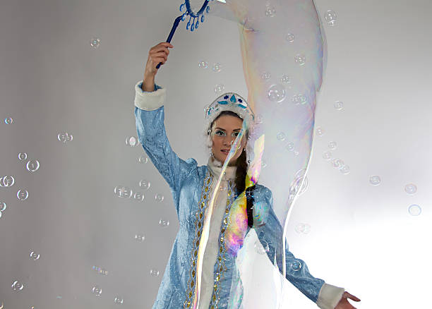 istock Image of snow maiden looking at soap bubbles 535555691