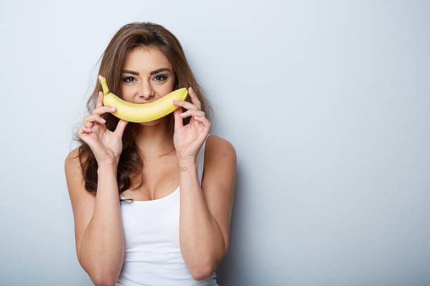 istock woman making fun with a banana 535555761