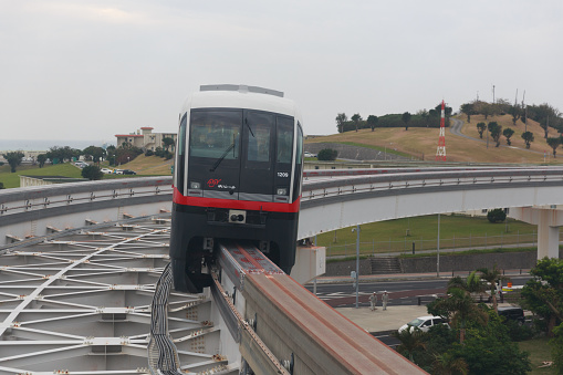 Naha, Japan - January 29, 2015 : Okinawa Monorail move past Akamine Station in Naha, Okinawa, Japan. It is the only public rail system in Okinawa Prefecture.