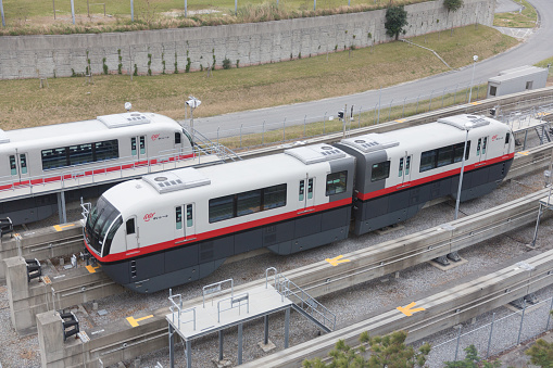 The Red Line electric train stops in Laksi Skytrain Station on Vibha Vadi Road Bangkok Thailand