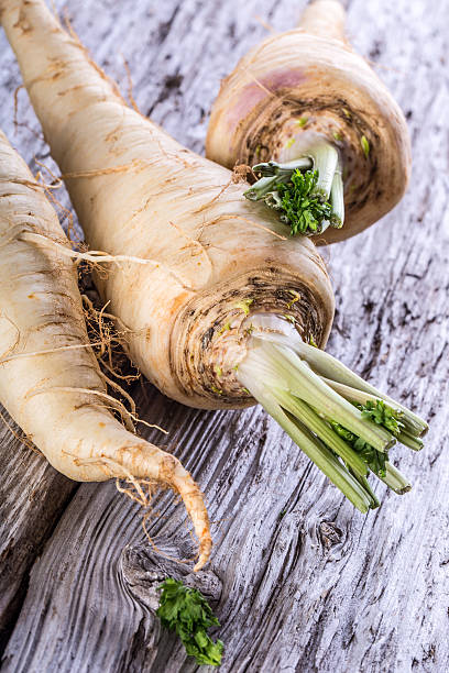 istock Fresh parsnip on old wooden table. 535557421