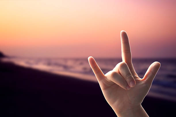 istock Hands love sign on sunset beach 535557691