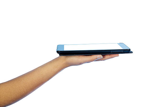 istock Woman's hand shows a Tablet PC. Isolated on white background. 535557763