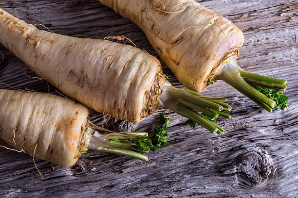 istock Fresh parsnip on old wooden table. 535558547
