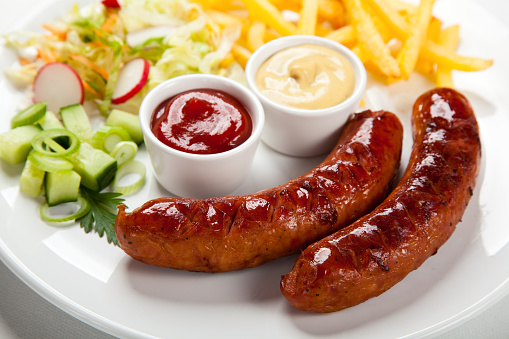 Grilled sausages with fries and vegetables 