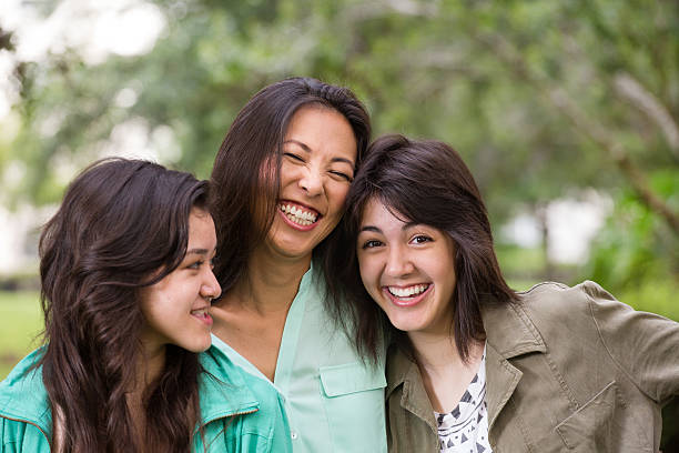 istock Asian mother and her daughters laughing 535565033