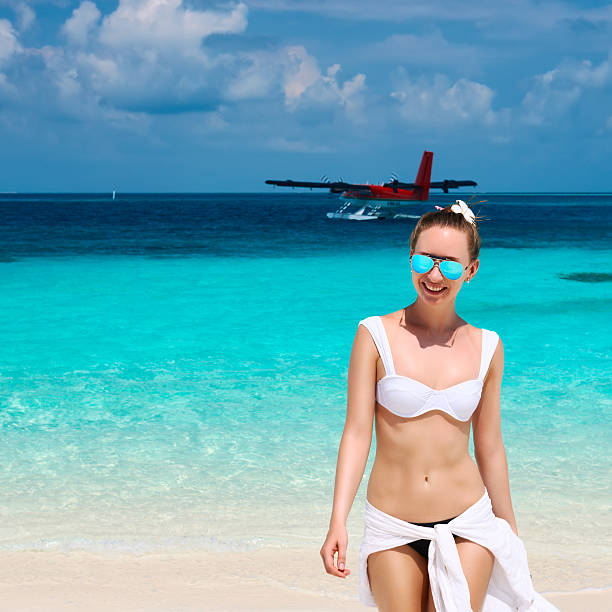 istock Woman at beach. Seaplane at background. 535565311
