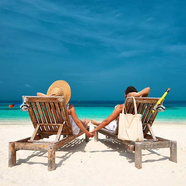 istock Couple in white relax on a beach at Maldives 535566333