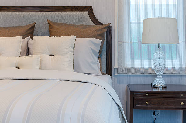 istock white pillows on white bed with luxury lamp in bedroom 535568513