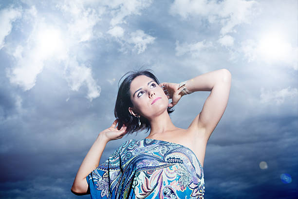 istock Young and beautiful woman with sky background and clouds 535569169
