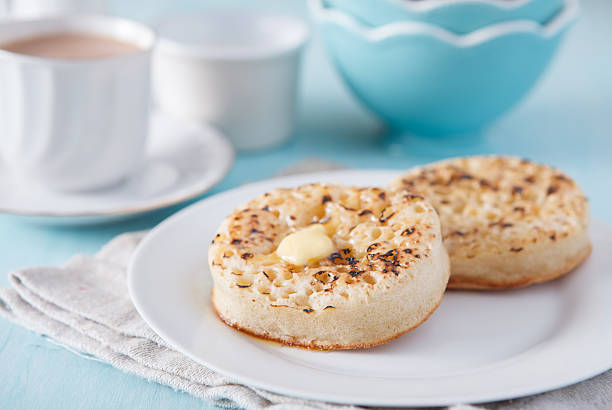 istock Hot buttered crumpets on the blue table with tea 535569903