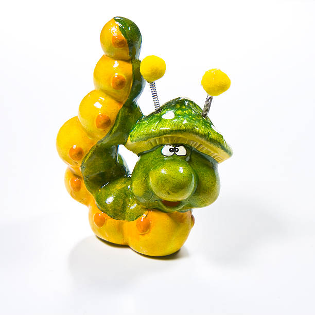 istock Small colorful ceramic caterpillar isolated on white. 535570267