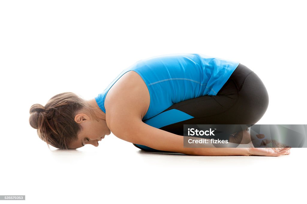 Yoga girl resting in Balasana Sporty yoga girl on white background relaxing after practice, Balasana, Child’s Pose 2015 Stock Photo