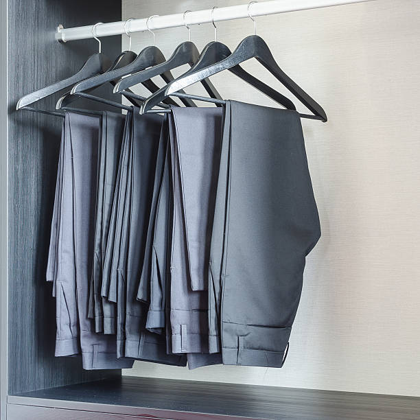 istock row of black pants hangs in wardrobe 535570523