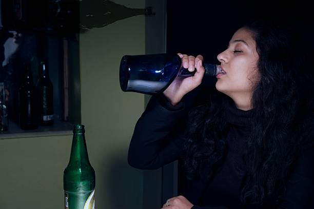 istock Alcoholic woman drinking with bottle. 535571039