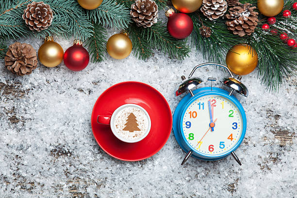 istock Cappuccino with christmas tree shape and clock on artificial sno 535572093