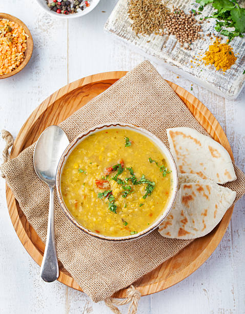 Lentil soup with bread in ceramic white bowl Top view Lentil soup with bread in a ceramic white bowl on a wooden background Top view soup lentil healthy eating dishware stock pictures, royalty-free photos & images