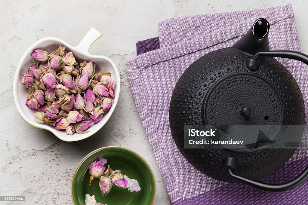 Asian rose tea and teapot Asian rose tea and teapot over stone table Above Stock Photo
