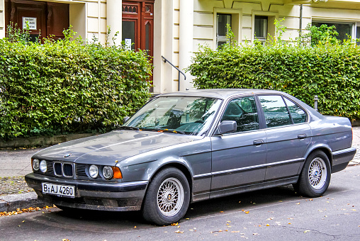 Berlin, Germany - September 10, 2013: Motor car BMW E34 5-series is parked in the city street.