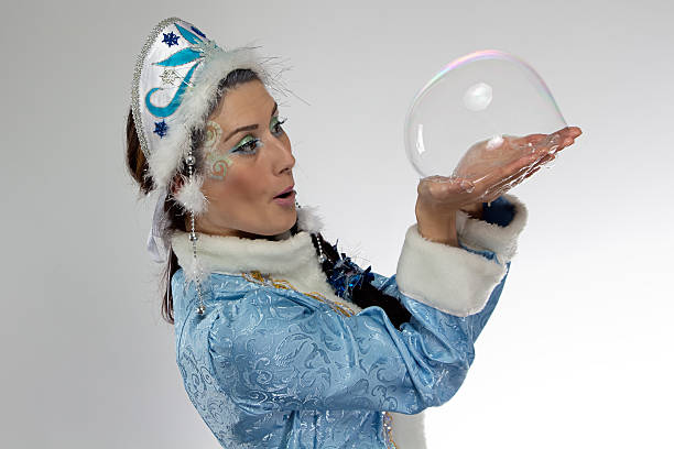 istock Image of snow maiden and soap bubble in her hands 535623837