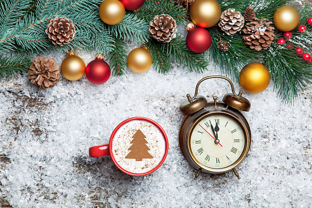 istock Cappuccino with christmas tree shape and clock on artificial sno 535623903