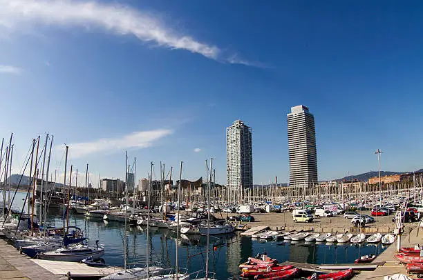 Barcelona harbor under the the blue sky with skyscrapers in background 