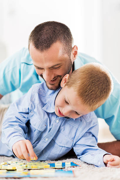 istock Happy father and son playing word game. 535625963