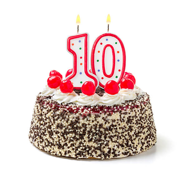 Birthday cake with burning candle number 10 Birthday cake with burning candle number 10 10 11 years photos stock pictures, royalty-free photos & images