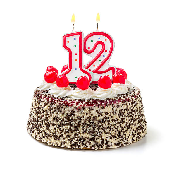 istock Birthday cake with burning candle number 12 535627471