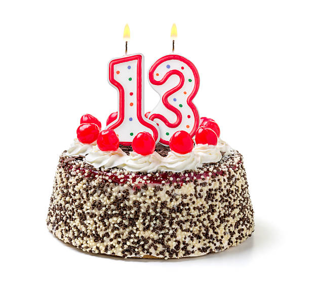 istock Birthday cake with burning candle number 13 535627473